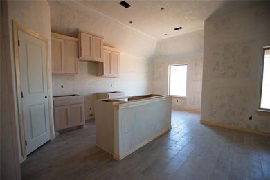 Kitchen featuring lofted ceiling, hardwood / wood-