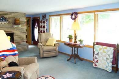 The living room has a wall of windows.