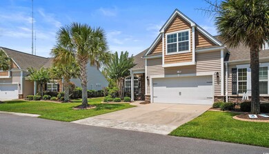 View of front of home with a garage and a front la