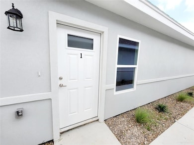Entrance to property with stucco siding