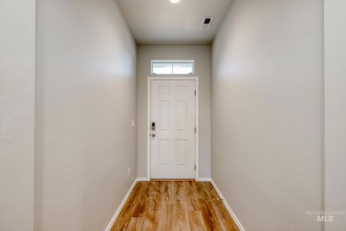 Entryway with baseboards and wood finished floors