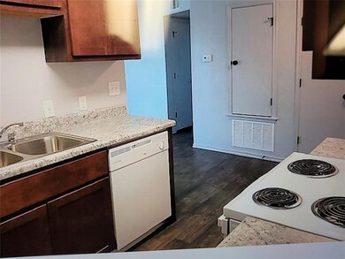 Kitchen with light countertops, a sink, white appl