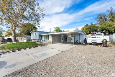 Split level home with driveway and an attached carport