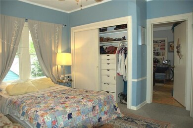 Bedroom with crown molding, a closet, and carpet 