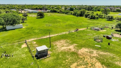 Birds eye view of property with a rural view