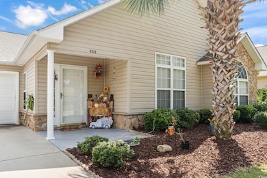 Entrance to property featuring a shingled roof and stone siding