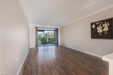 Unfurnished room with ornamental molding and dark 