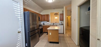 The kitchen has a laundry area adjacent to it. The
