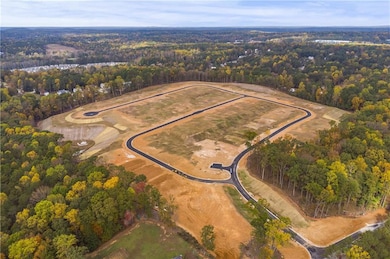 View of property location with a heavily wooded ar