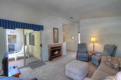 Living room view back to entry door.  Balcony conn