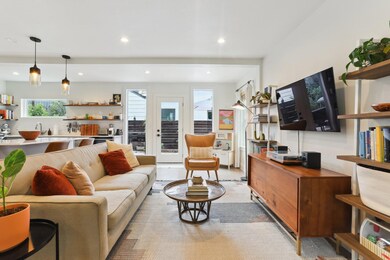 Living area with recessed lighting and light wood