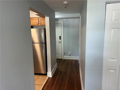 Corridor with wood finished floors and baseboards