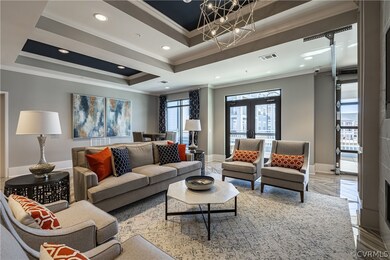 Living room with a tray ceiling, french doors, cro