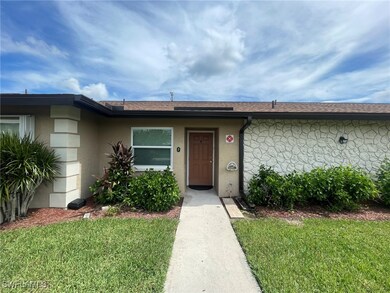 View of exterior entry with a yard