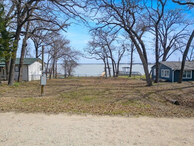 View of yard with a water view and fence