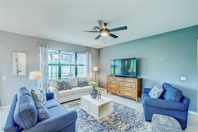 Living room featuring ceiling fan and light tile p