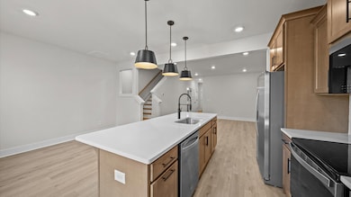 Wooden cabinetry kitchen in two story townhome at Clayton Crossing by DRB Homes in Arden, NC