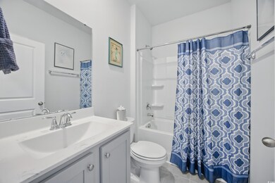 Bathroom featuring vanity, toilet, shower / tub combo, and tile patterned flooring