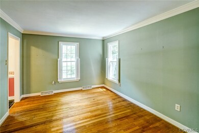 Empty room with ornamental molding and wood-type f