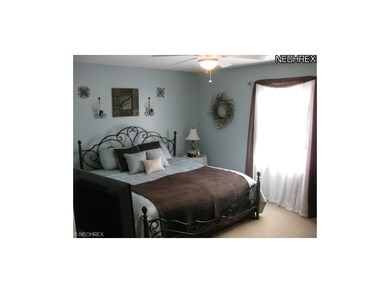 The master bedroom has plush carpeting and a ceili