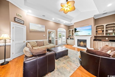 Living room with ceiling fan, light hardwood / woo