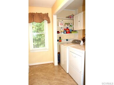 Utility room off the kitchen with cabinets and she