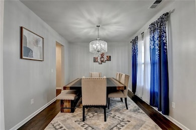 Dining room featuring a chandelier and dark wood finished floors