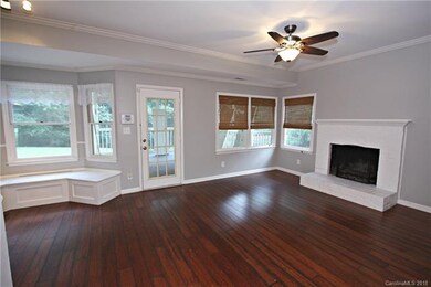 Family room with wood burning fireplace. Door onto