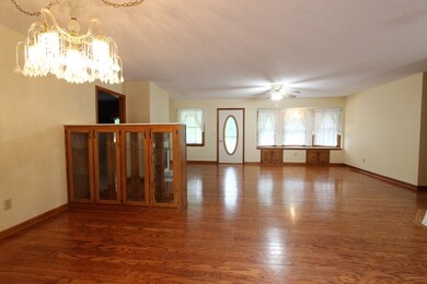 View of the living room and the bay window from the dining room area