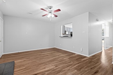 Unfurnished room featuring a ceiling fan, wood fi