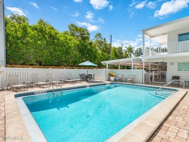 Community pool featuring a patio and outdoor dinin
