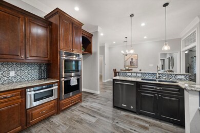 Kitchen with sink, crown molding, hanging light fi