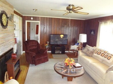 Den or family room is located next to kitchen on one side with hall way to bedrooms on the other side.