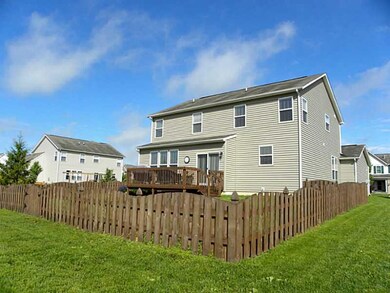 Exterior Back. Large fenced-in back yard for play and a deck for outdoor BBQs.