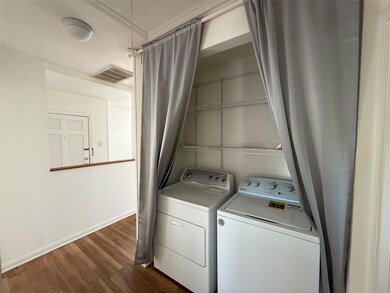 Washroom featuring washer and dryer, dark wood-st