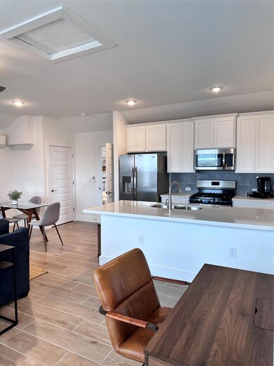 Kitchen featuring stainless steel refrigerator wi