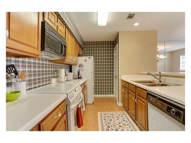 Photo. The kitchen is galley style with wood cabin