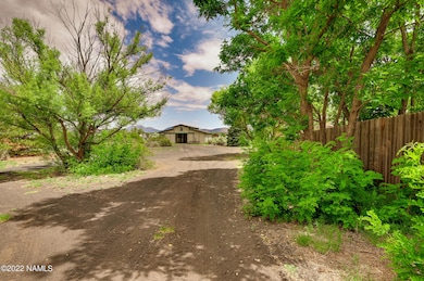 barn and home beyond trees