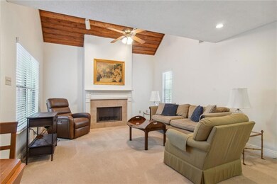 Living Room w/fireplace + vaulted ceilings.