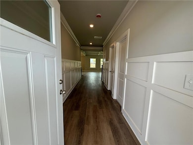 Hall with ornamental molding and dark wood-type fl