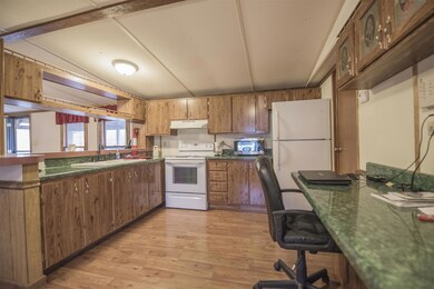 Open kitchen, smooth top stove and ceramic sink,  laminate floors. Refrigerator stays. 