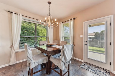 Dining room with a chandelier and baseboards