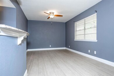 Unfurnished room featuring a ceiling fan and wood
