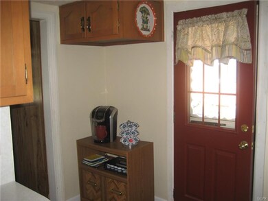 View of kitchen with door leading to covered porch