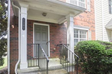 Doorway to property featuring brick siding