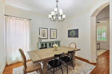 Dining room featuring a notable chandelier, dark h