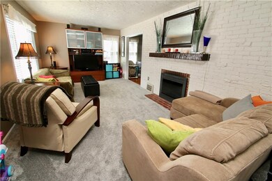 Living room with full brick wall fireplace