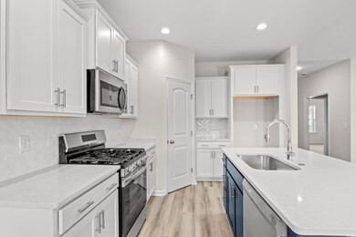 Kitchen featuring backsplash, stainless steel appl