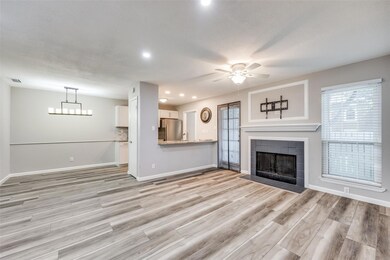 Unfurnished living room featuring ceiling fan, a f