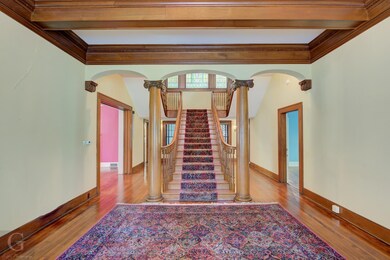 Beautiful stairway of golden oak flanked on both s